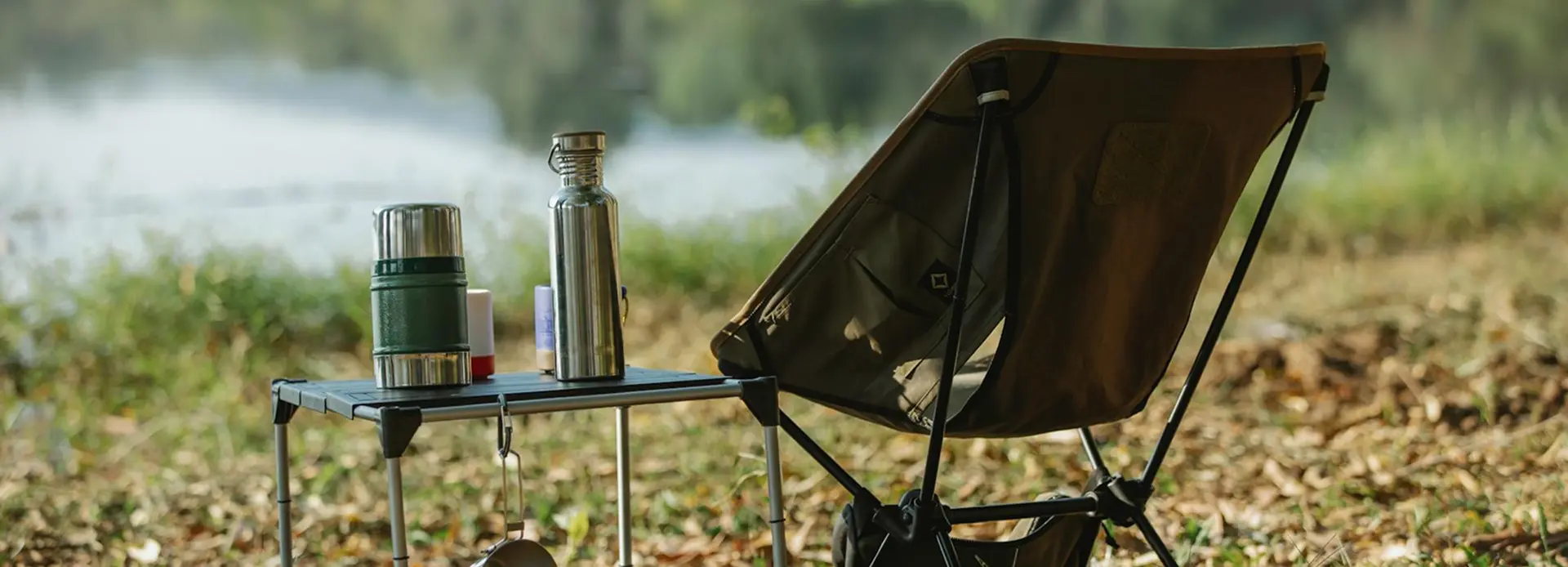 Several camp chairs set up at an outdoor campsite, showing different sizes, frames, and seat heights